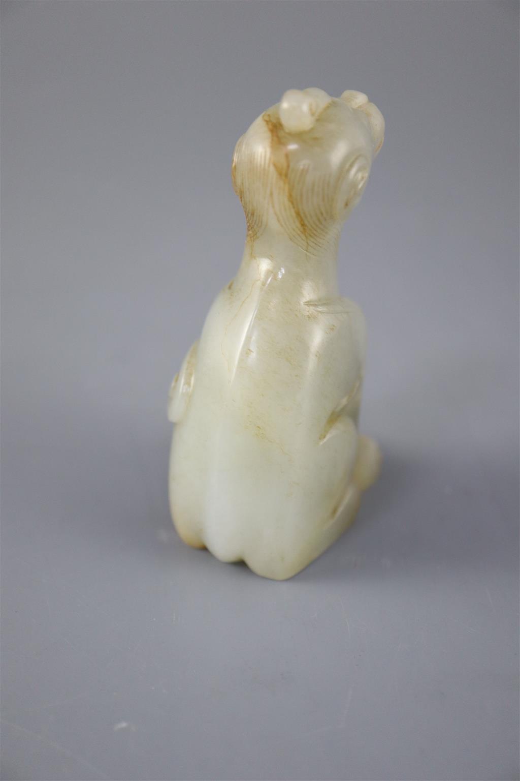 A Chinese pale celadon and russet jade figure of a mythical beast, 7.5cm high